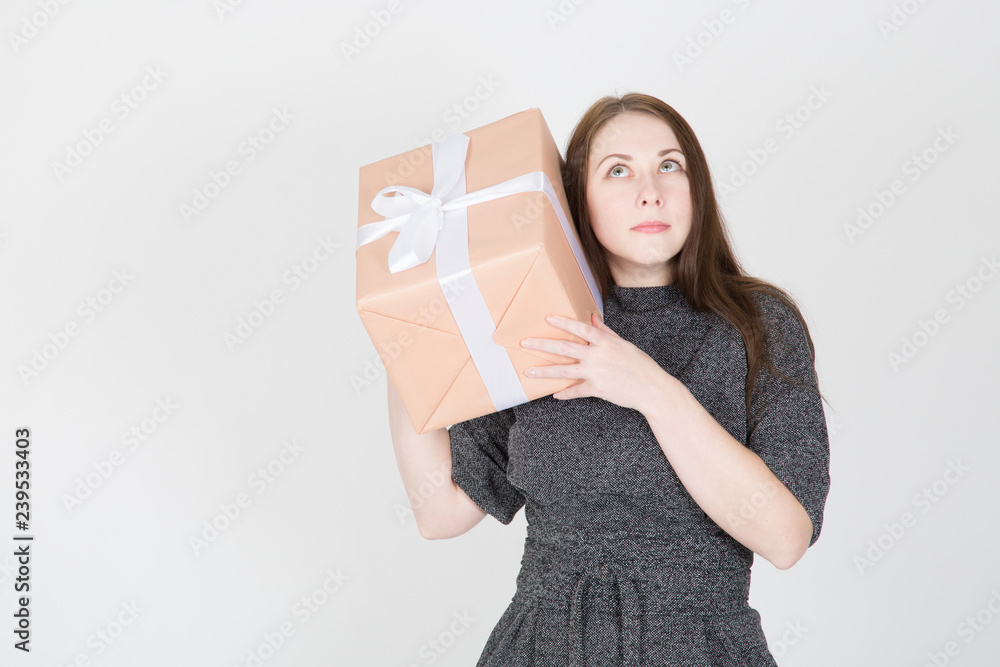 Portrait of a happy young woman in sunglasses isolated, holding present box Portrait of a happy young woman in sunglasses isolated, holding present box