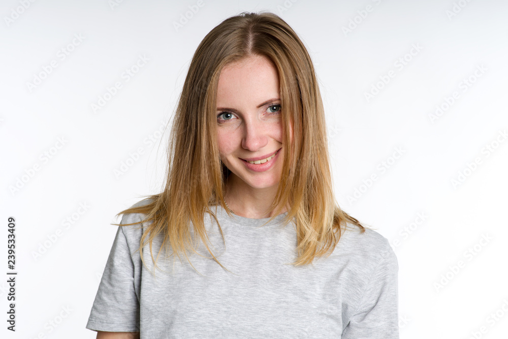 Portrait of a smiling woman in a shirt on a light background. Portrait of a smiling woman in a shirt on a light background.