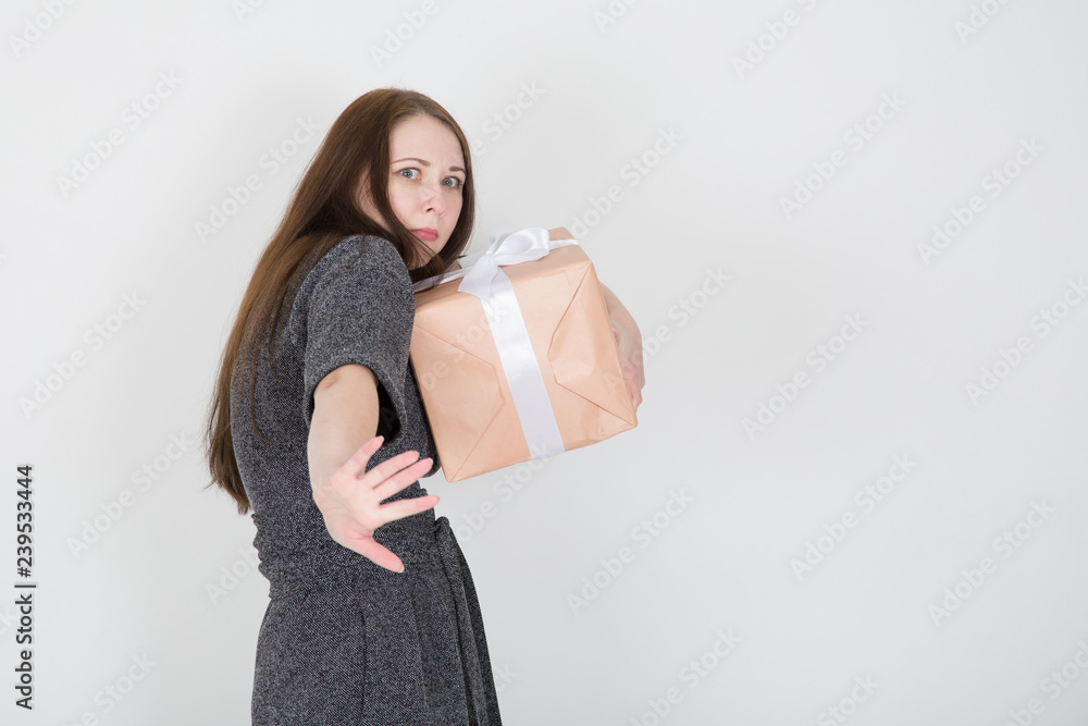 portrait of a funny young woman clutching a present box portrait of a funny young woman clutching a present box