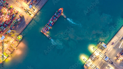 Container ship in export and import business logistics and transportation. Cargo and container box shipping to harbor by crane. Water transport International. Aerial view and top view. photo
