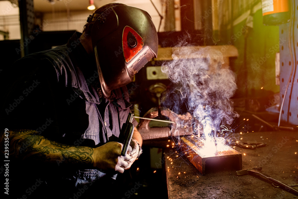 Man working the weld in the workshop