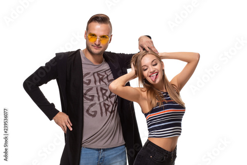 Funny young couple posing in studio. Isolated on white background