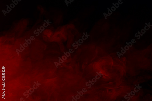 magical red cigarette vapor on a dark background bewitching and mysterious background for design