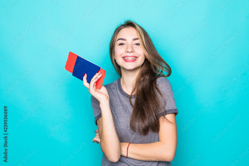 Young Woman traveler with passport and ticket on blue background Young Woman traveler with passport and ticket on blue background