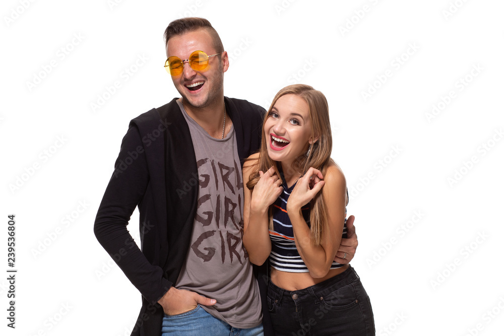 Happy young lovely couple standing together and laughing. Studio shot over white background. Happy young lovely couple standing together and laughing. Studio shot over white background.