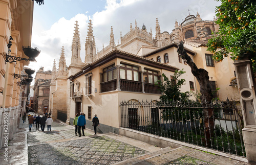 Old houses and 16 Granada Cathedral with tourists walking around at autumn season