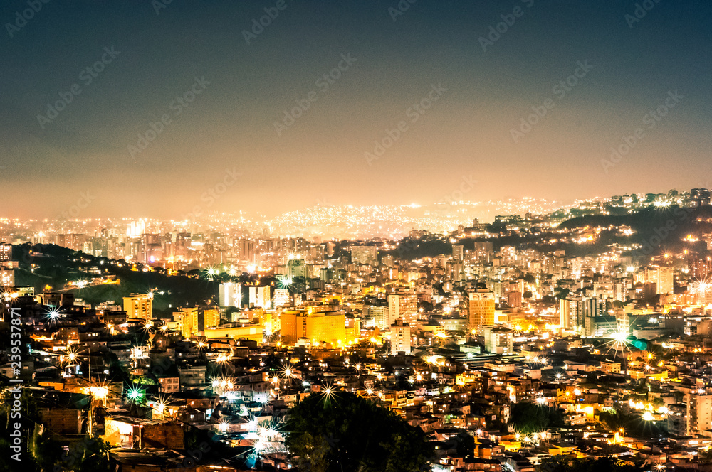 night view cityscape of caracas during summer clear sky with view of hills with the slums, so called barrios