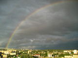 Rainbow over a city. Aerial view of a rainbow over the city..