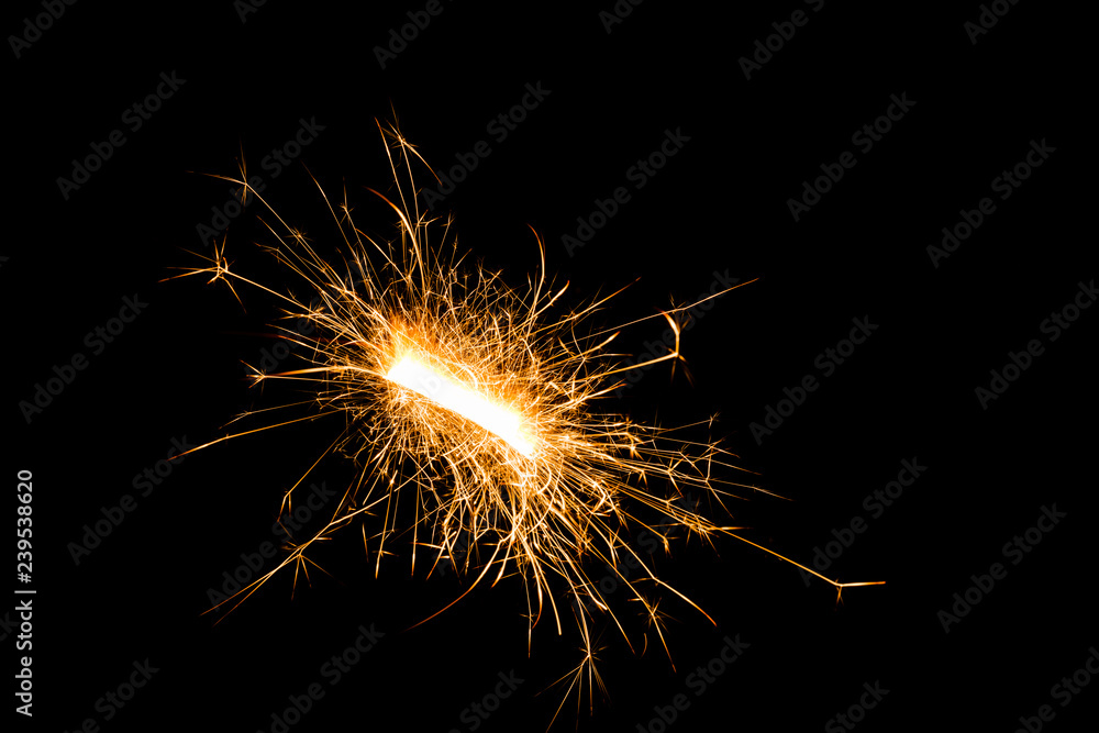 Close-up view of festive Christmas sparkler on black background