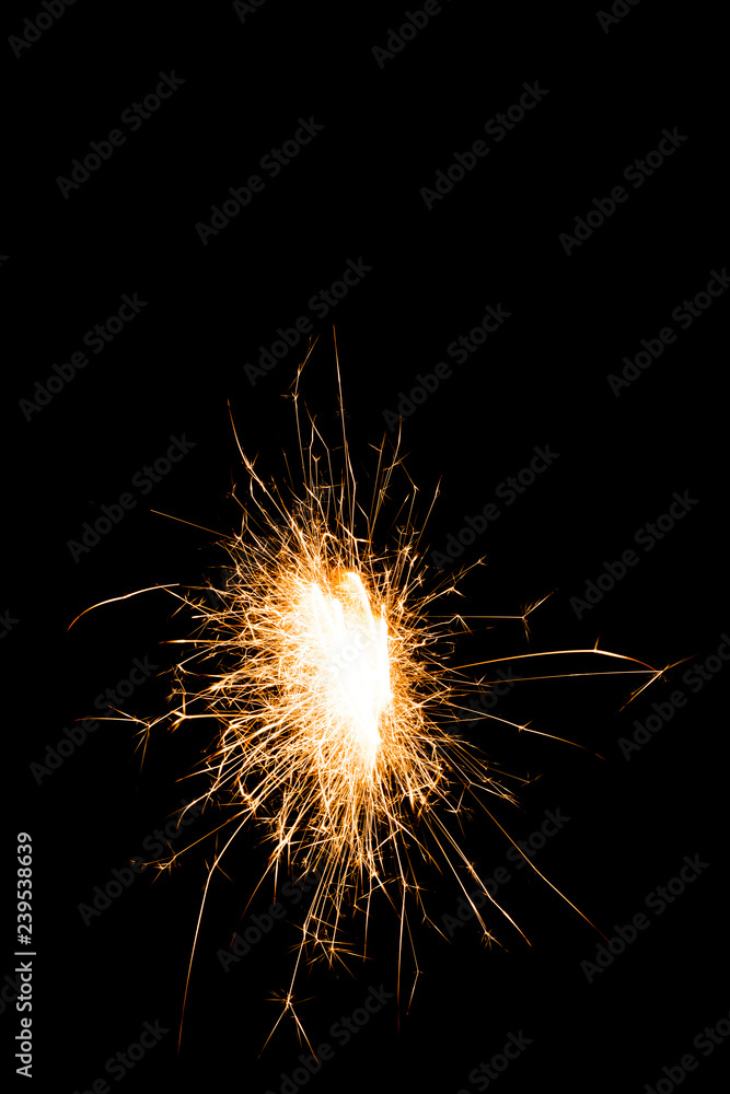 Close-up view of bright glowing new year sparkler on black background