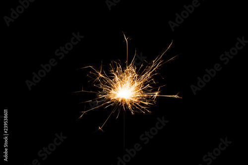 Close-up view of festive new year sparkler on black background