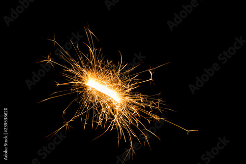 Close-up view of festive Christmas sparkler on black background