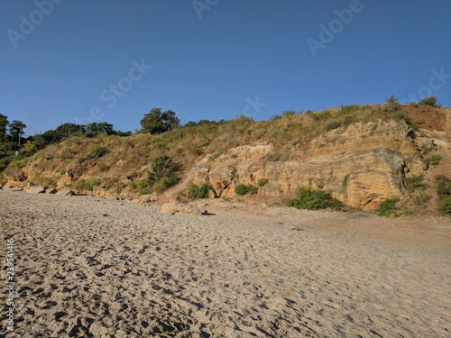 Yellow sand cliffs and beach Summer background