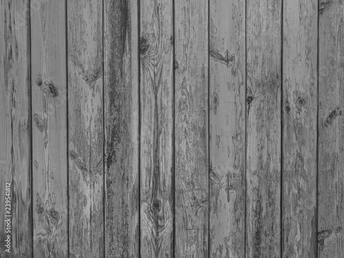 Old dark black and white vintage rustic aged antique wooden panel with vertical gaps, planks and chinks background texture
