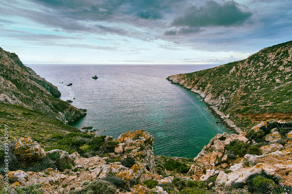 View of a turquoise bay in Corsica Corse France on a cloudy summer day