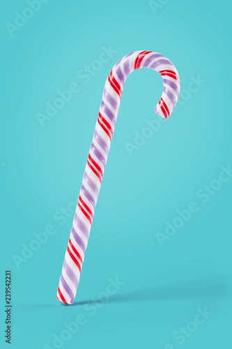 Candy cane isolated on a colorful background. Sweets symbol