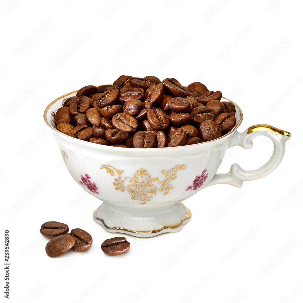 Heap of coffee beans in porcelain antique coffee cup isolated on white background. Heap of coffee beans in porcelain antique coffee cup isolated on white background.