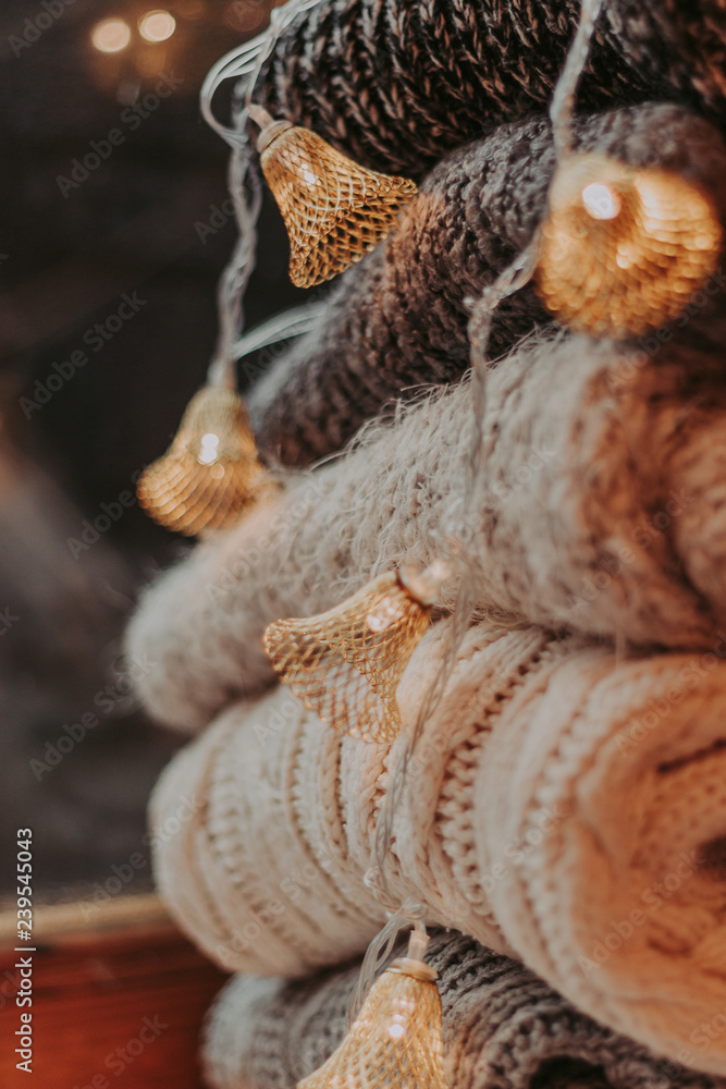 A bunch of sweaters, light bulbs, lanterns, cozy winter interior details, home decor and comfort. A bunch of sweaters, light bulbs, lanterns, cozy winter interior details, home decor and comfort.