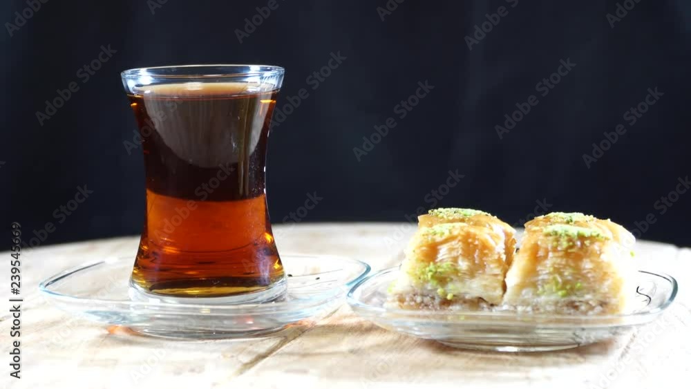 The legendary Turkish baklava and Turkish tea. Turkey cuisine. 4K The legendary Turkish baklava and Turkish tea. Turkey cuisine. 4K