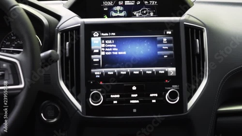 Young woman's hand operating car radio