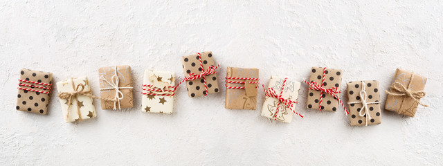 Christmas banner with decorated Christmas gift boxes on white background. Holiday packaging, copy space, flat lay.