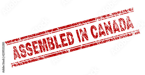 ASSEMBLED IN CANADA seal watermark with corroded texture. Red vector rubber print of ASSEMBLED IN CANADA caption with scratched texture. Text caption is placed between double parallel lines.
