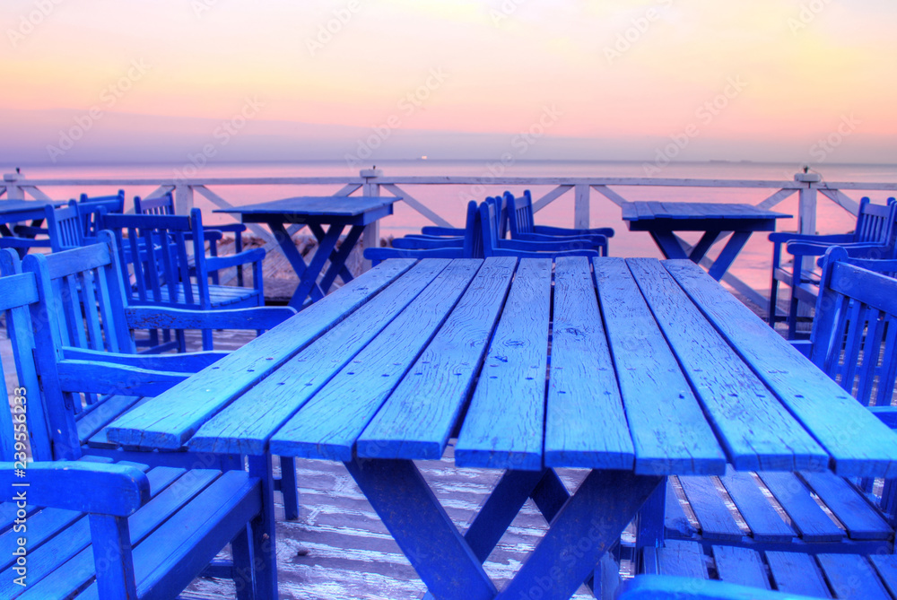 Empty top of wooden table and view of sunset or sunrise background. Ibiza Beach Cafe