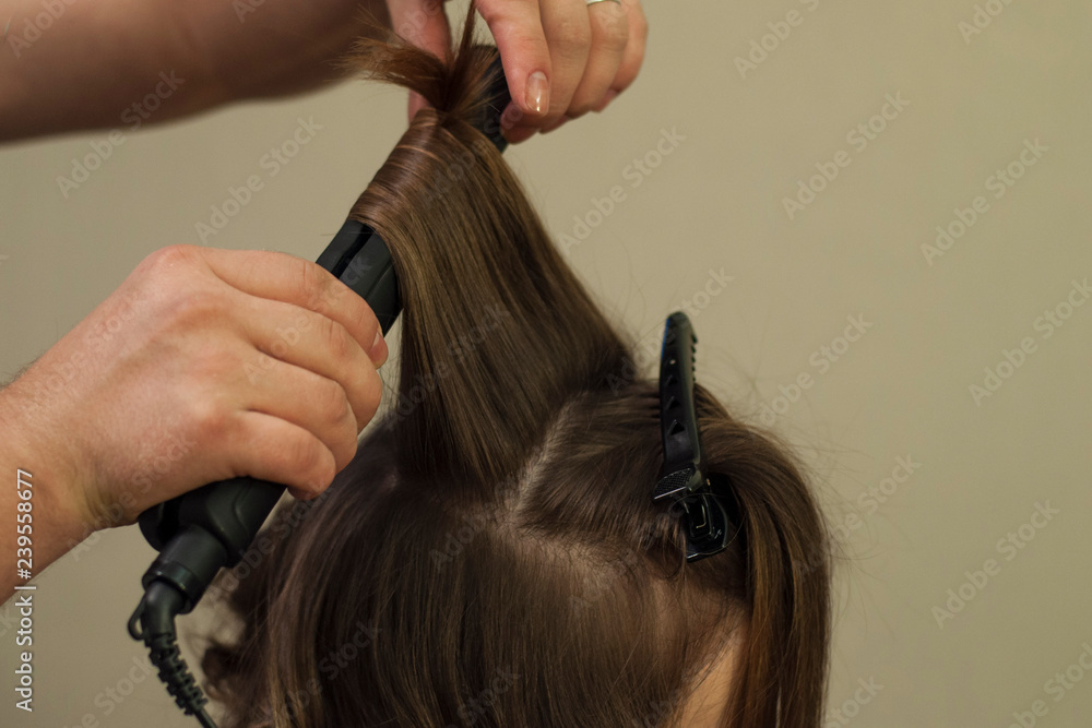 Hairdresser working at the beauty studio salon, making hair style. Hairdresser working at the beauty studio salon, making hair style.