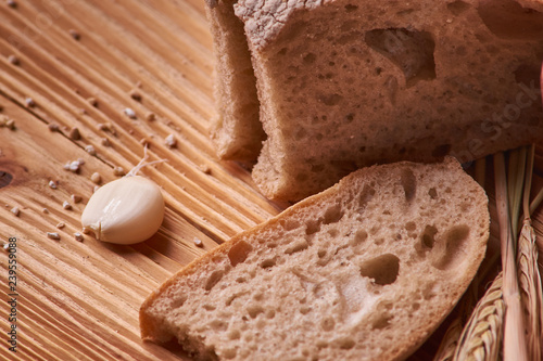 slices of bread and crumbs and garlik on wooden table. pleace for text. Copyspace photo