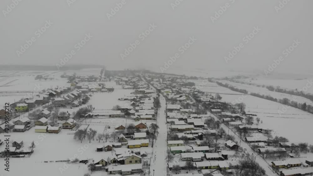 Aerial view of Ukrainian village. Snowy winter day. Smooth flight back, 4k Aerial view of Ukrainian village. Snowy winter day. Smooth flight back, 4k