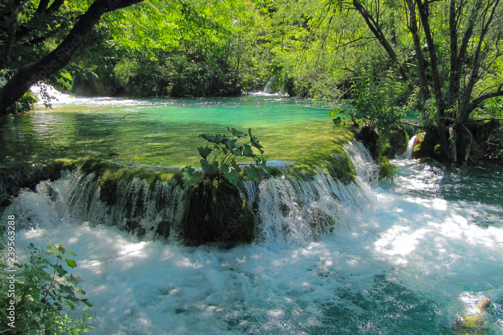 waterfall with small cascades of water in the Plitvice lakes national Park in Croatia.