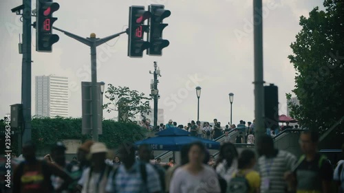 Lots of people walking on the street in Shanghai by day photo