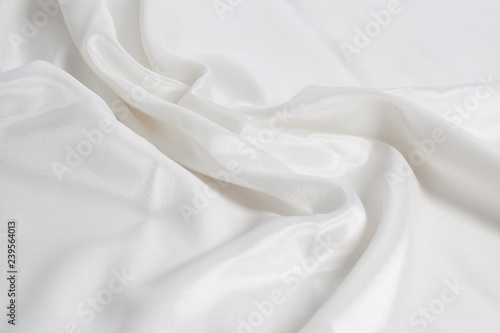 Closeup of rippled white silk fabric background