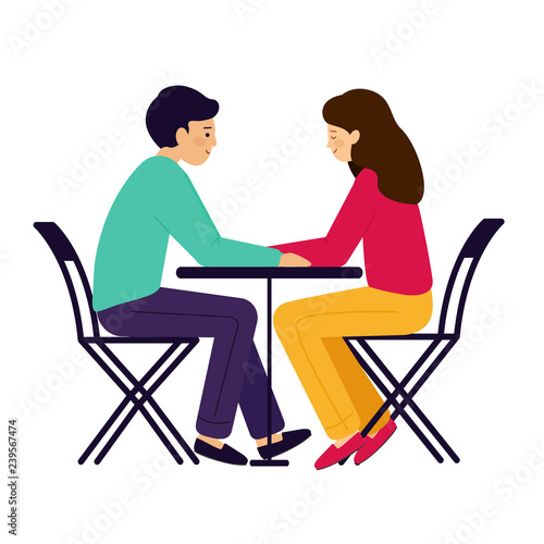 Girl and guy sitting at the table. A couple of man and woman talking. 