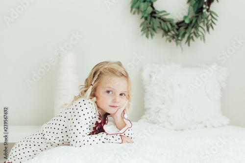 Young girl leaning on a bed
