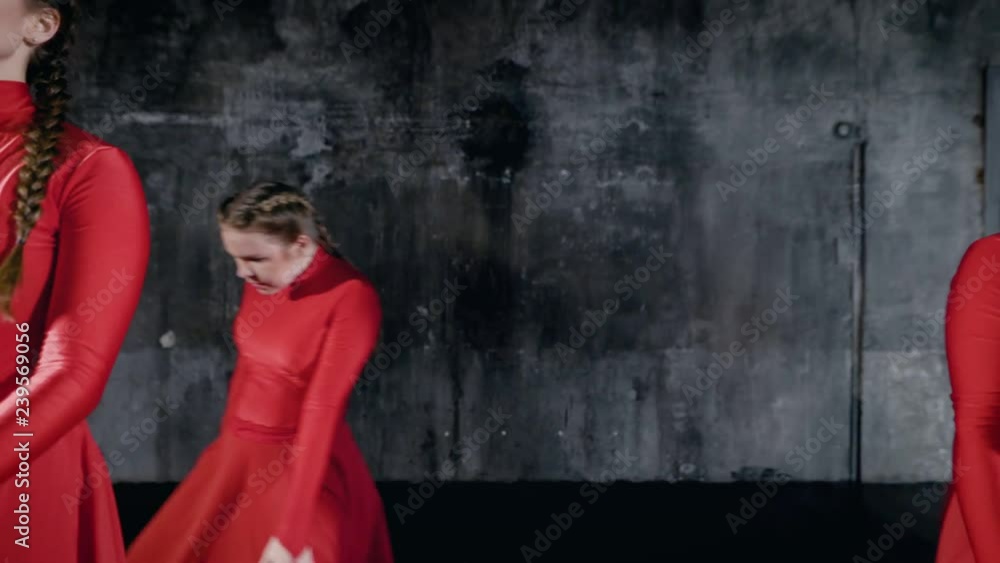 Beautiful girl in red costumes doing a dance show indoor. Beautiful girl in red costumes doing a dance show indoor.