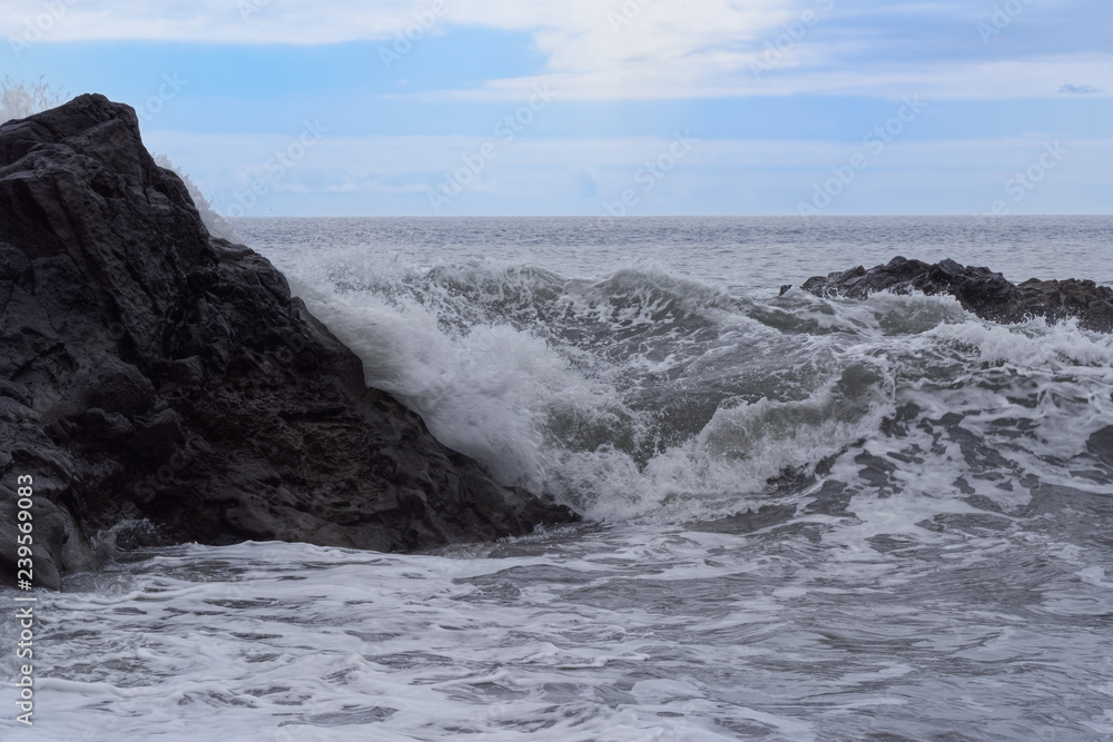 Waves breaking on the rock