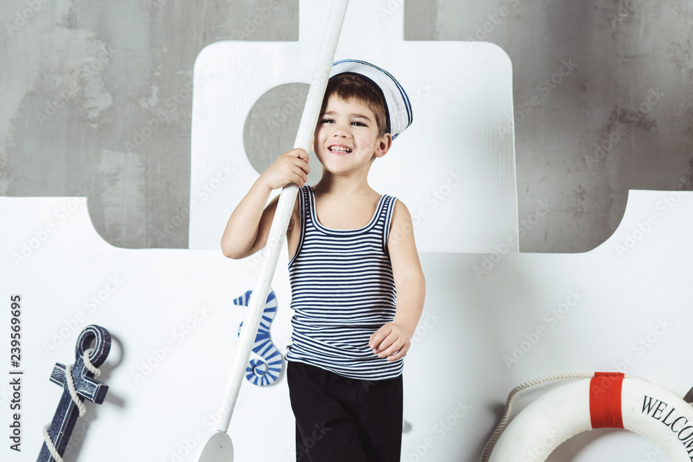 Cabin boy playing with paddle in front of stylized ship Cabin boy playing with paddle in front of stylized ship