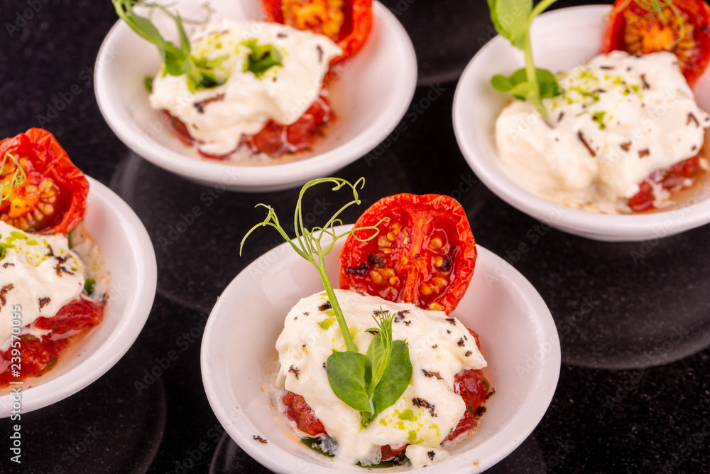 Portion cheese mozzarella with dried tomatoes and greens Portion cheese mozzarella with dried tomatoes and greens
