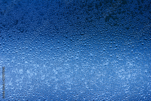 Macro abstract background design of window condensation in blue hues