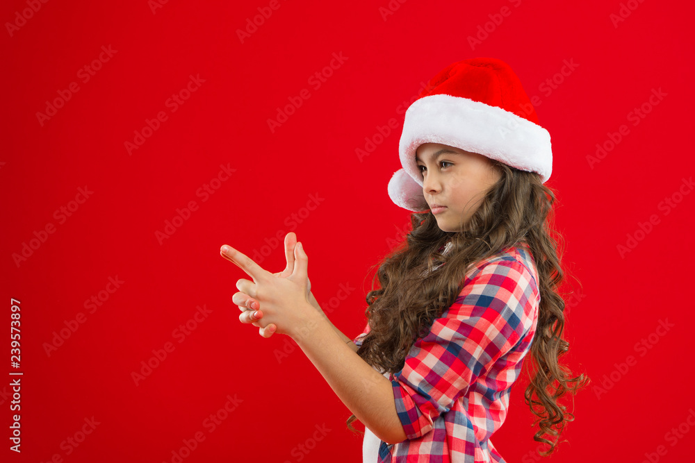 Little girl child in santa hat. Christmas shopping. Happy winter holidays. Small girl. Present for Xmas. Childhood. New year party. Santa claus kid. playing kid. All I want for Christmas