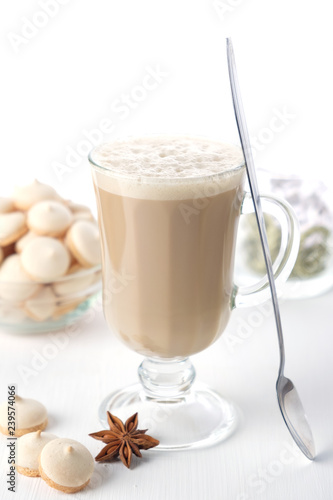 A glass of hot latte coffee with sweet cookies. Symbolic image.