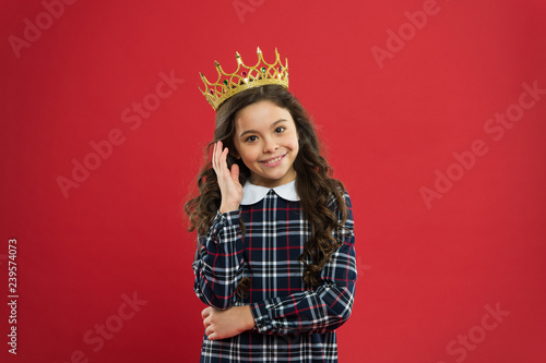 Elegancy suit her. Kid wear golden crown symbol of princess. Every girl dreaming to become princess. Lady little princess. Girl wear crown red background. Monarch family concept. Princess manners