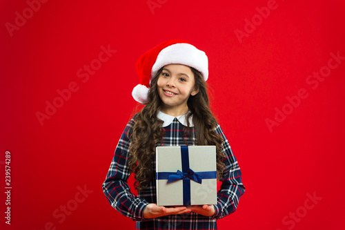 Christmas shopping. Little girl child in santa red hat. Present for Xmas. Childhood. New year party. Santa claus kid. Happy winter holidays. Small girl. for my parents