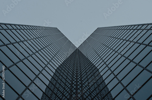 The corner glass looking up on the building in the downtown city area. 