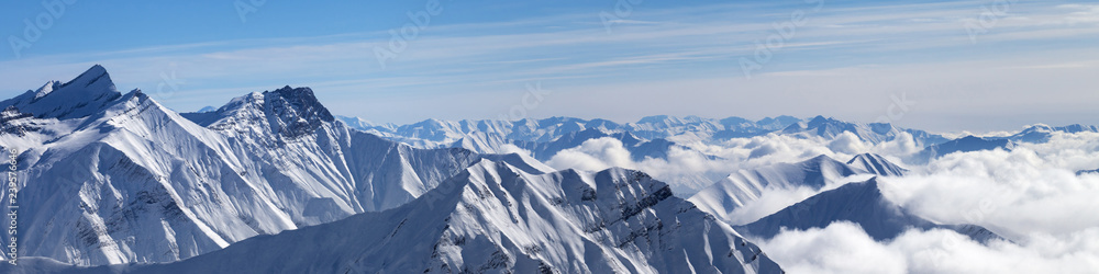 Panorama of snowy mountains in clouds - obrazy, fototapety, plakaty 