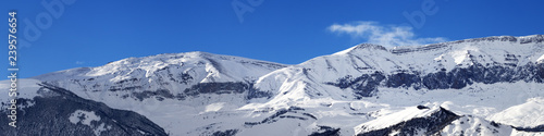 Panorama of winter snowy mountains at sunny day