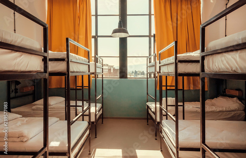 Bunk beds inside bedroom with big window and yellow curtains