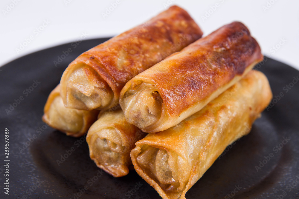 Chinese Traditional Spring rolls on a black plate Chinese Traditional Spring rolls on a black plate