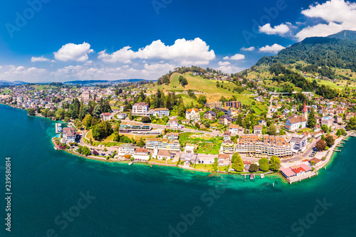 Village Weggis, lake Lucerne (Vierwaldstatersee), Rigi mountain and Swiss Alps in the background near famous Lucerne city, Switzerland photo